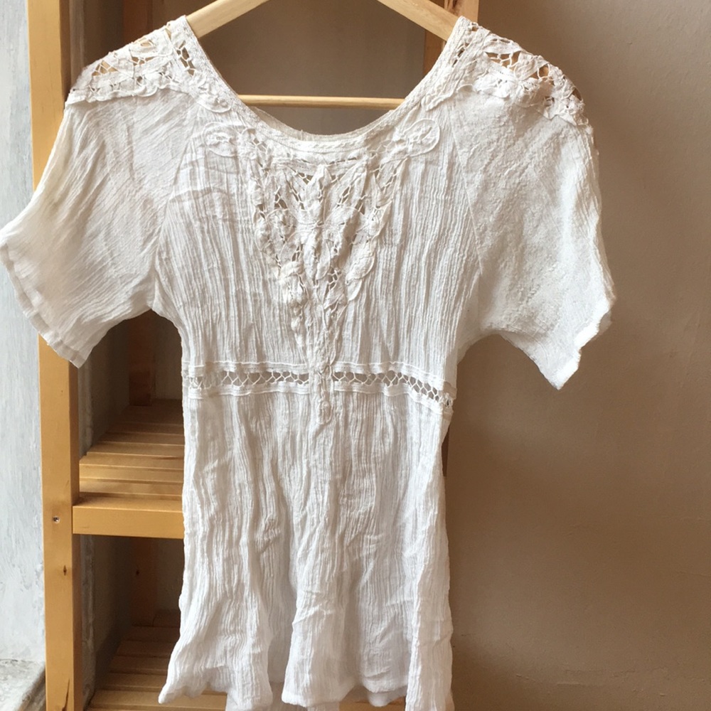 Flowy white blouse with macrame cutouts